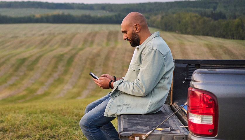 Customer using a mobile phone beside a truck